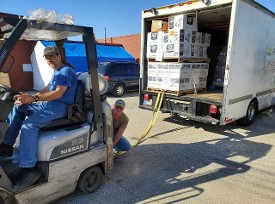 Good News Mission helps us unload our truck of Donations from Midwest Foods