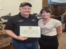 Heather  Harvey presenting Don Hawkins with a Certificate of Appreciation from Congressman's Carson's Office for 10 years of Service for MACV members